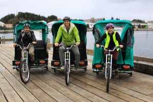 Bill the Giant, left, Michael Bricker, center, and Tess Olympia Ramsey with their Sitka Pedicabs, a new business launching this week in Sitka.
