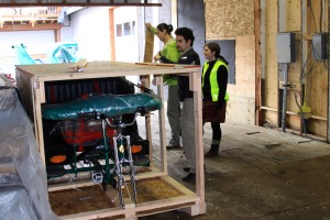 Michael Bricker, left, Bill the Giant, center, and Tess Olympia Ramsey uncrate one of the new Sitka Pedicabs on April 21, 2012.