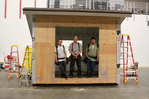 Pacific High School students Jake Kranz (left) and Scott Thomas (right) pose with University of Alaska Southeast Sitka Campus construction technology assistant professor Pat Hughes in a covered bike shelter they're building for the high school.